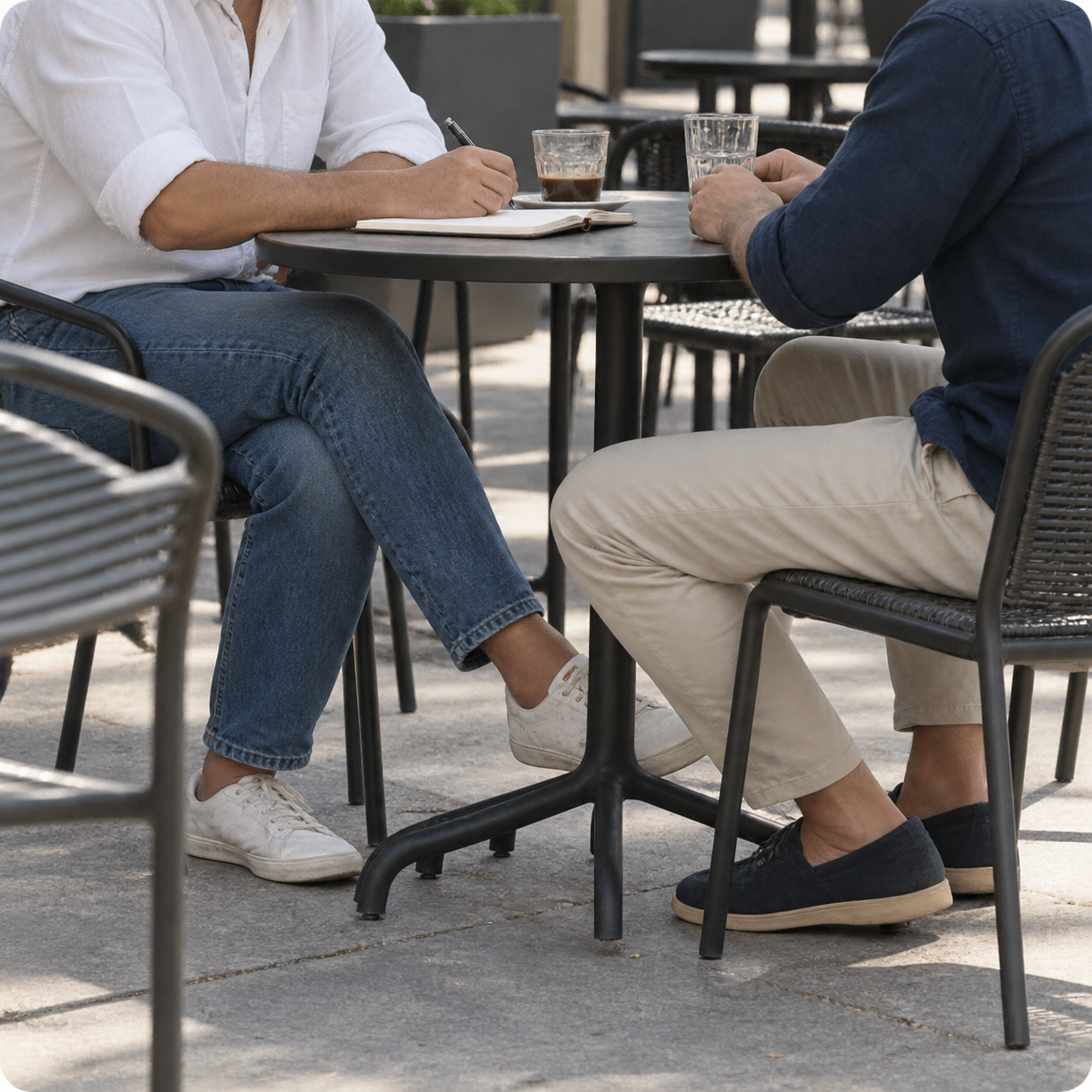 Two people practicing conversation at an outdoor café.
